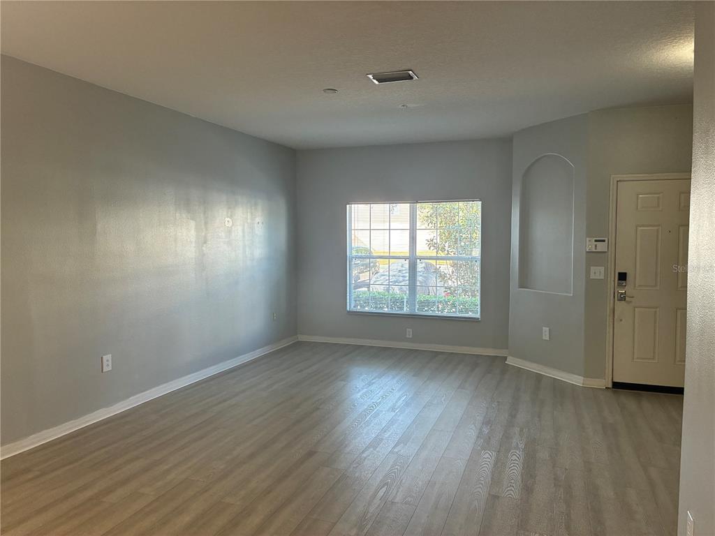 1110 Sleepy Oak Drive Wesley Chapel, FL 33543 - Photo 2 of 35 an empty room with wooden floor and windows