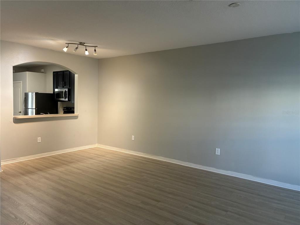 1110 Sleepy Oak Drive Wesley Chapel, FL 33543 - Photo 4 of 35 a view of an empty room with wooden floor and a window