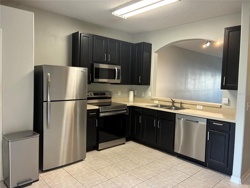 1110 Sleepy Oak Drive Wesley Chapel, FL 33543 - Photo 6 of 35 a kitchen with stainless steel appliances granite countertop a refrigerator stove a sink and dishwasher