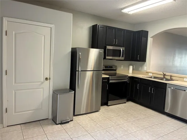 a kitchen with a refrigerator sink and microwave