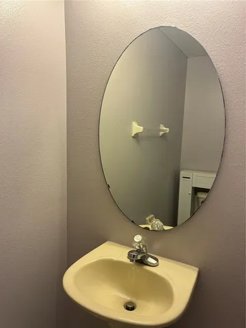 a bathroom with a sink and mirror
