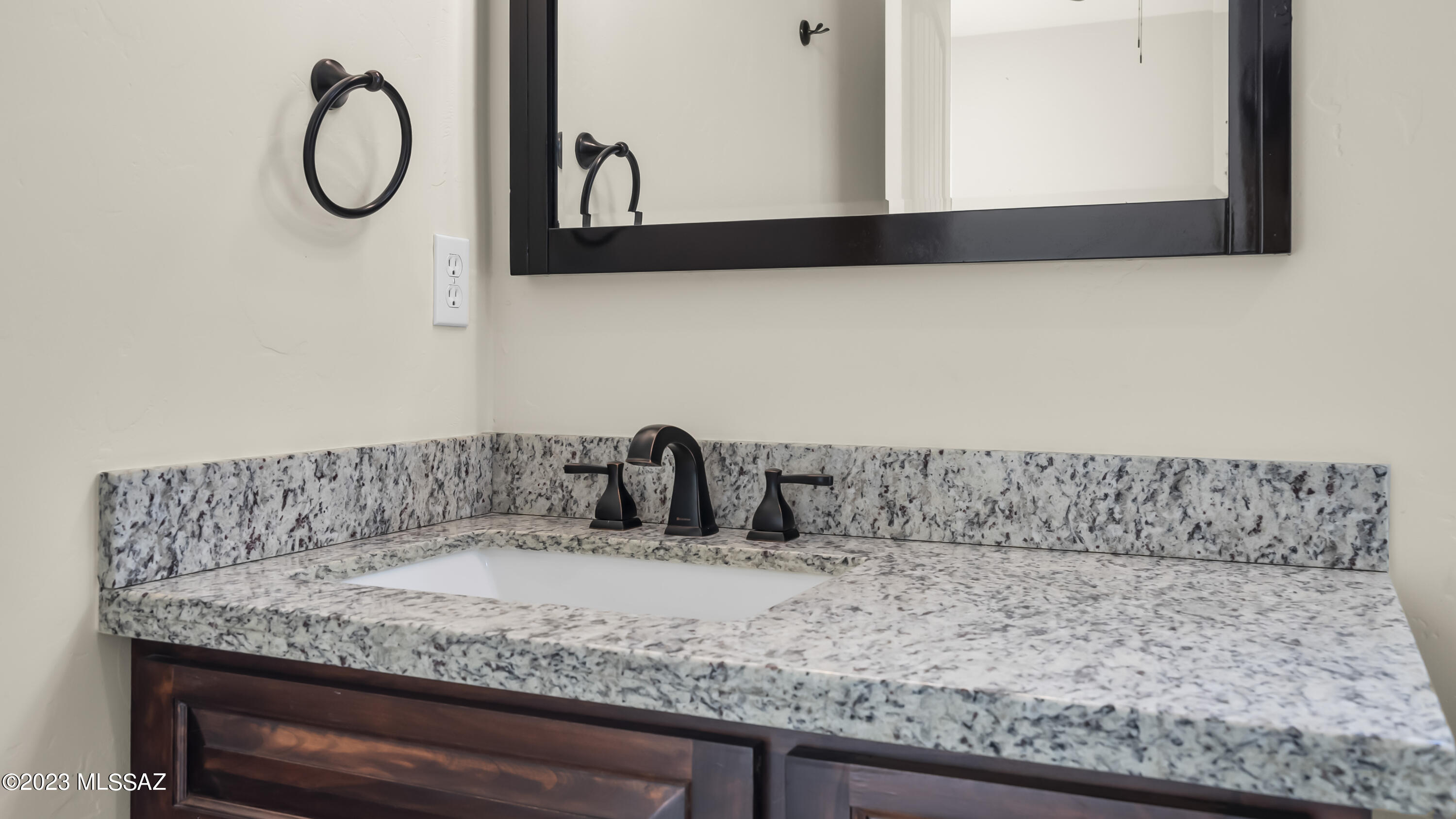 1799 Saltillo Court Rio Rico, AZ 85648 - Photo 18 of 25 a bathroom with a granite countertop sink and a mirror