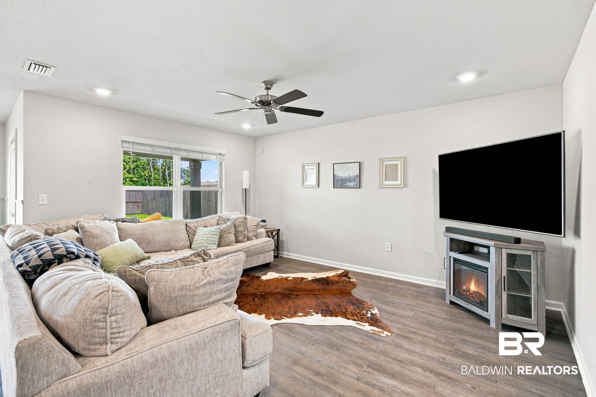 32155 Terranova Loop Lillian, AL 36549 - Photo 8 of 37 Spacious living area featuring wood-finish flooring, recessed lighting, and a ceiling fan