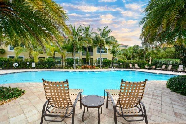 4212 Expedition Way Osprey, FL 34229 - Photo 2 of 28 a view of swimming pool outdoor seating and green space