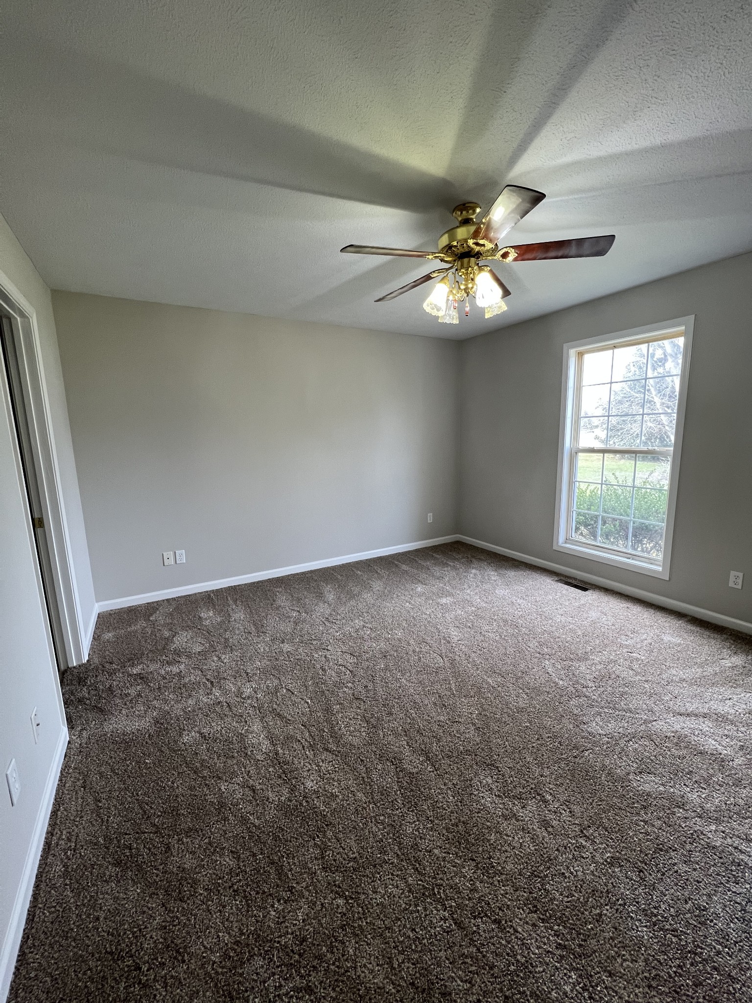 337 Browns Road Lafayette, TN 37083 - Photo 4 of 13 an empty room with windows and fan