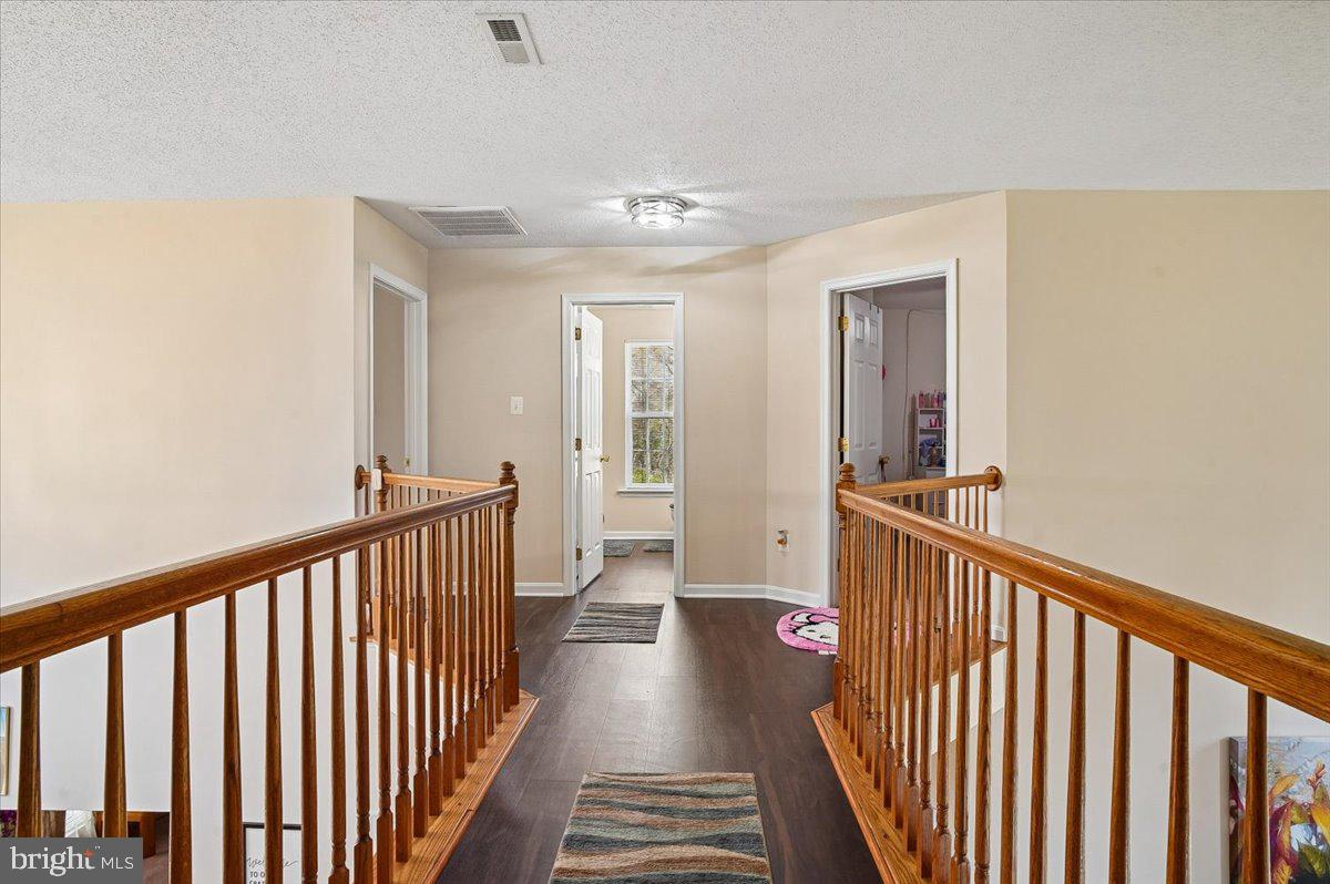 3470 Malcolm Road Brandywine, MD 20613 - Photo 12 of 36 a view of a hallway with wooden floor and stairs