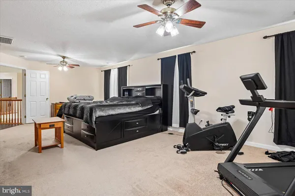 a room with gym equipment and a flat screen tv