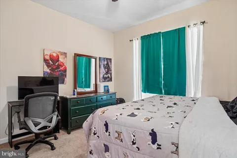 a bedroom with a bed chair and a window