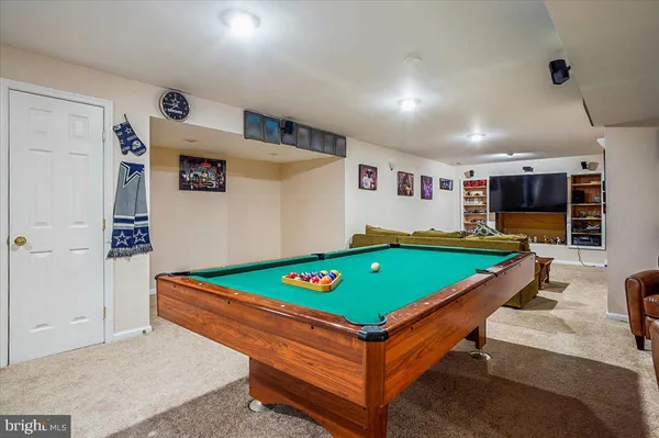 a room with pool table and flat screen tv