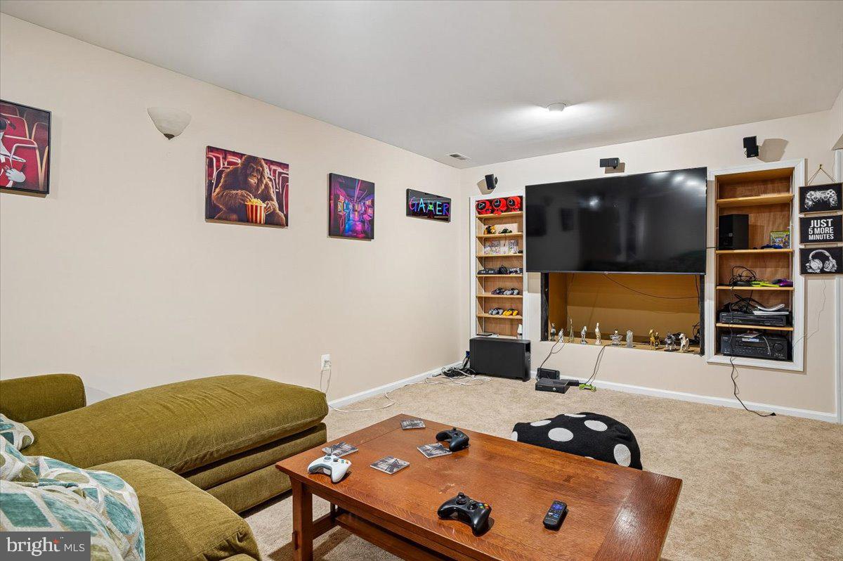 3470 Malcolm Road Brandywine, MD 20613 - Photo 26 of 36 a bedroom with a bed and a flat screen tv