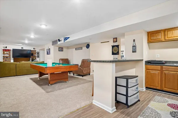 a living room with furniture and a kitchen view