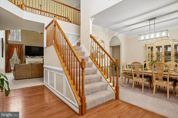 a view of a livingroom with furniture wooden floor and windows