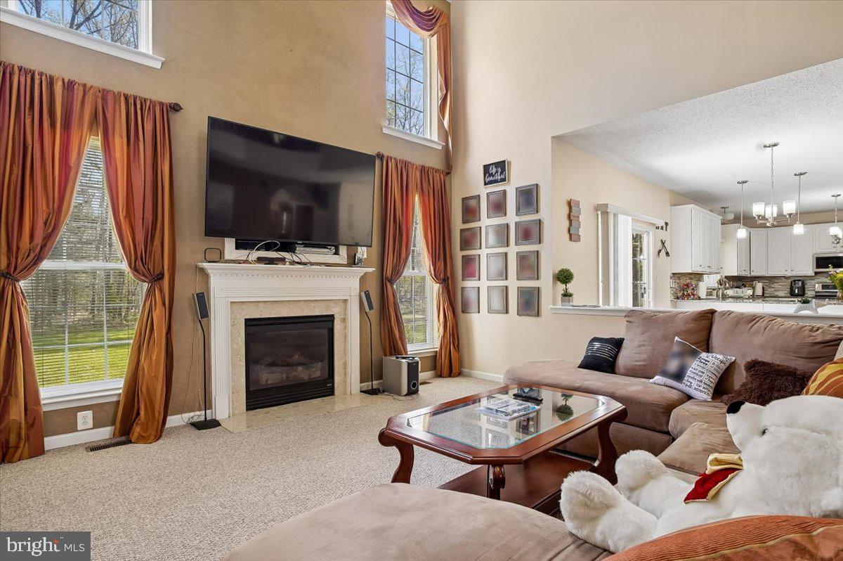 3470 Malcolm Road Brandywine, MD 20613 - Photo 4 of 36 a living room with furniture a flat screen tv and a fireplace