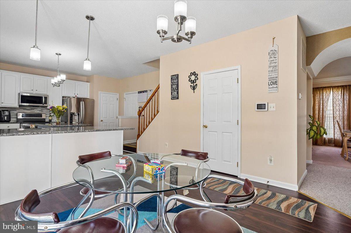 3470 Malcolm Road Brandywine, MD 20613 - Photo 8 of 36 a living room with furniture a rug and kitchen view