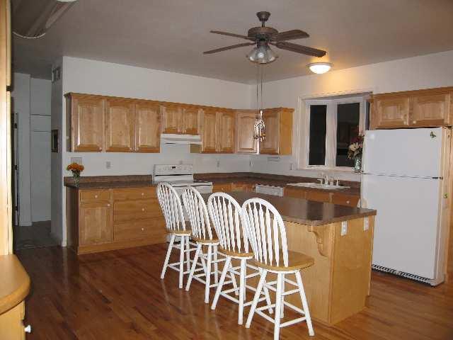 369 County Road 251 Rifle, CO 81650 - Photo 7 of 9 a kitchen with kitchen island a stove a sink and a refrigerator