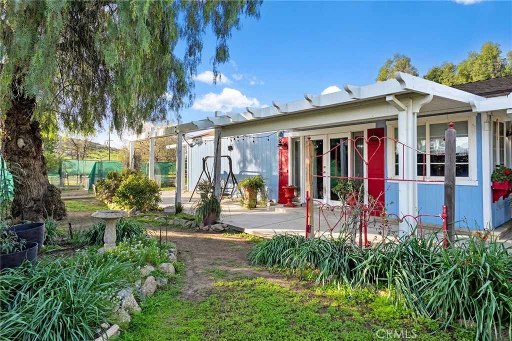 31615 Leon Road Winchester, CA 92596 - Photo 2 of 61 a view of a house with potted plants and a table and chairs