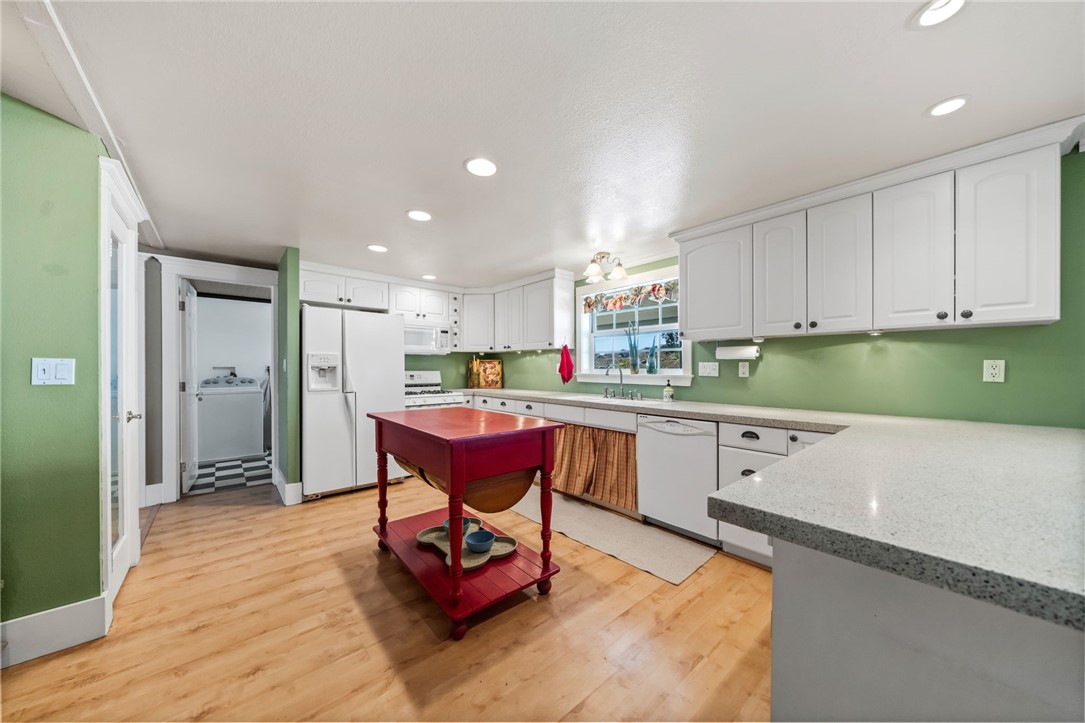 31615 Leon Road Winchester, CA 92596 - Photo 21 of 61 a kitchen with a dining table chairs and white cabinets