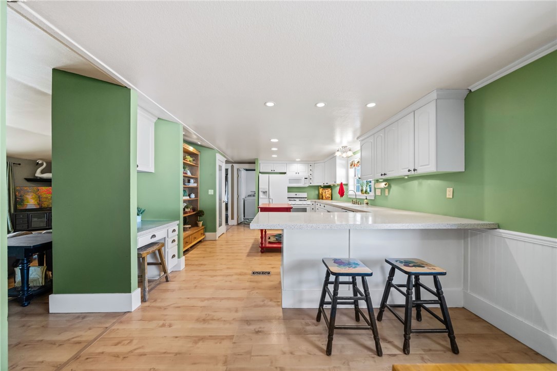 31615 Leon Road Winchester, CA 92596 - Photo 22 of 71 a kitchen with stainless steel appliances kitchen island granite countertop a table and chairs in it