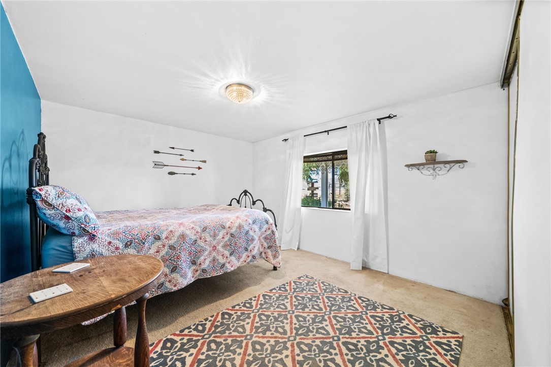 31615 Leon Road Winchester, CA 92596 - Photo 25 of 61 a bedroom with a bed and wooden floor