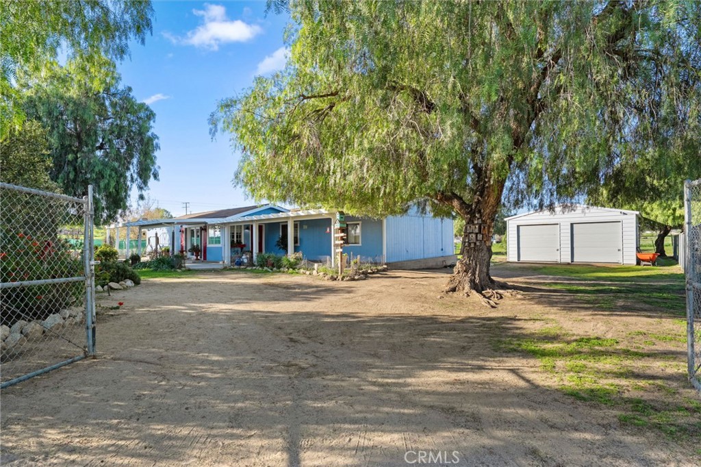 31615 Leon Road Winchester, CA 92596 - Photo 3 of 71 a front view of a house with a garden