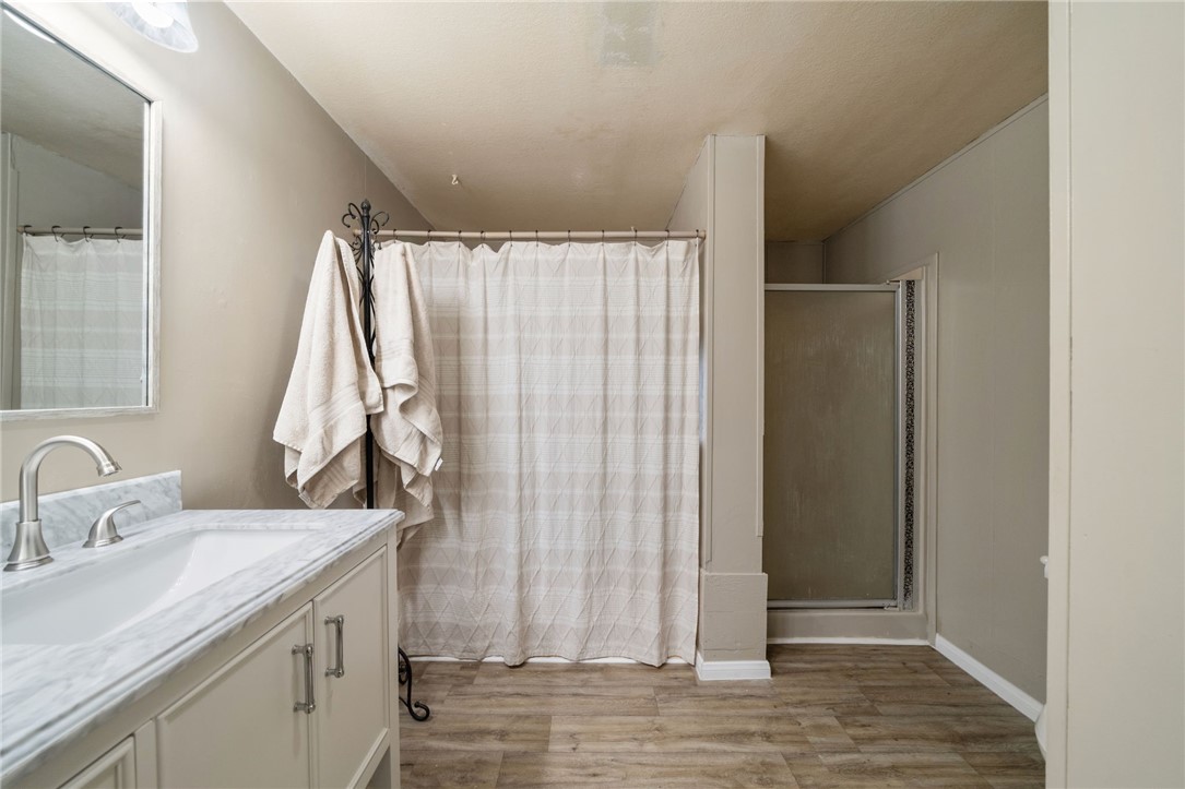 31615 Leon Road Winchester, CA 92596 - Photo 31 of 61 a bathroom with a granite countertop sink and a mirror