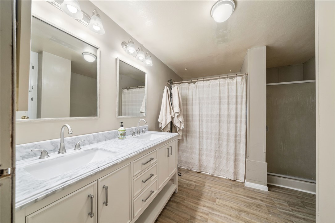31615 Leon Road Winchester, CA 92596 - Photo 32 of 71 a bathroom with a double vanity sink and a mirror
