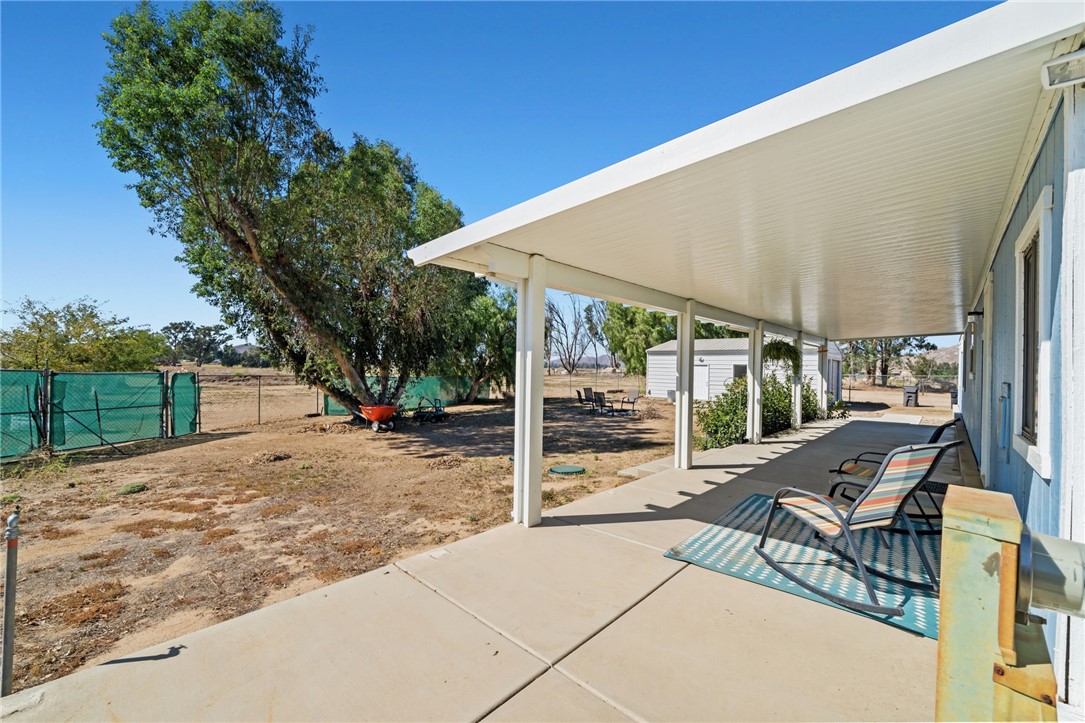 31615 Leon Road Winchester, CA 92596 - Photo 35 of 61 a view of a patio with table and chairs and floor to ceiling window