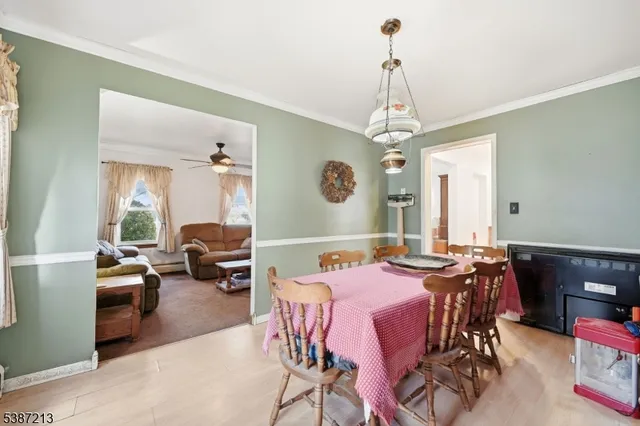 a view of a a dining room with furniture window and wooden floor