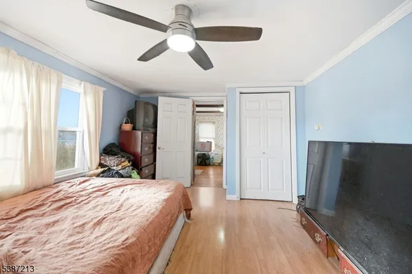 a bed room with a bed and a flat screen tv