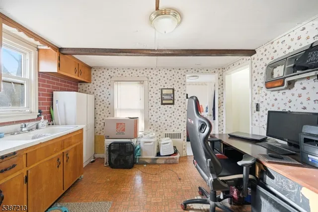 a room with furniture a flat screen tv and a window