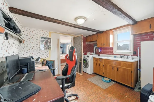 a view of a kitchen with fridge and workspace