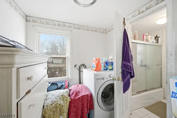 a view of a bedroom with washer and dryer