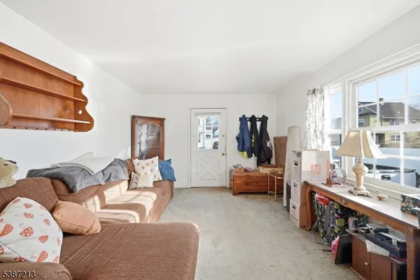 a living room with furniture and baby gym
