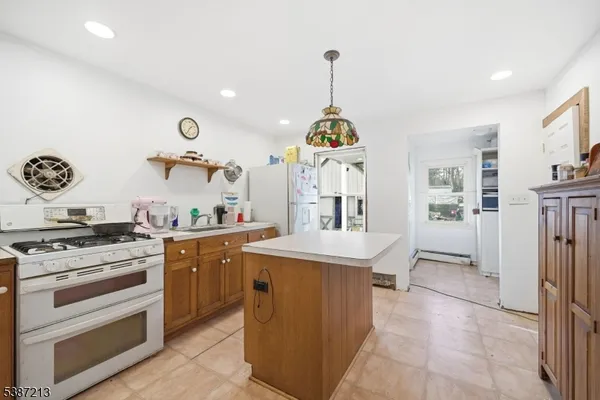 a kitchen with stainless steel appliances granite countertop a stove and a sink