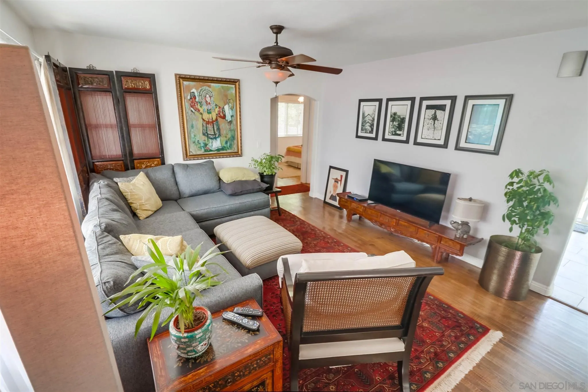 10436 Don Pico Road Spring Valley, CA 91978 - Photo 4 of 25 a living room with furniture a fireplace and a potted plant