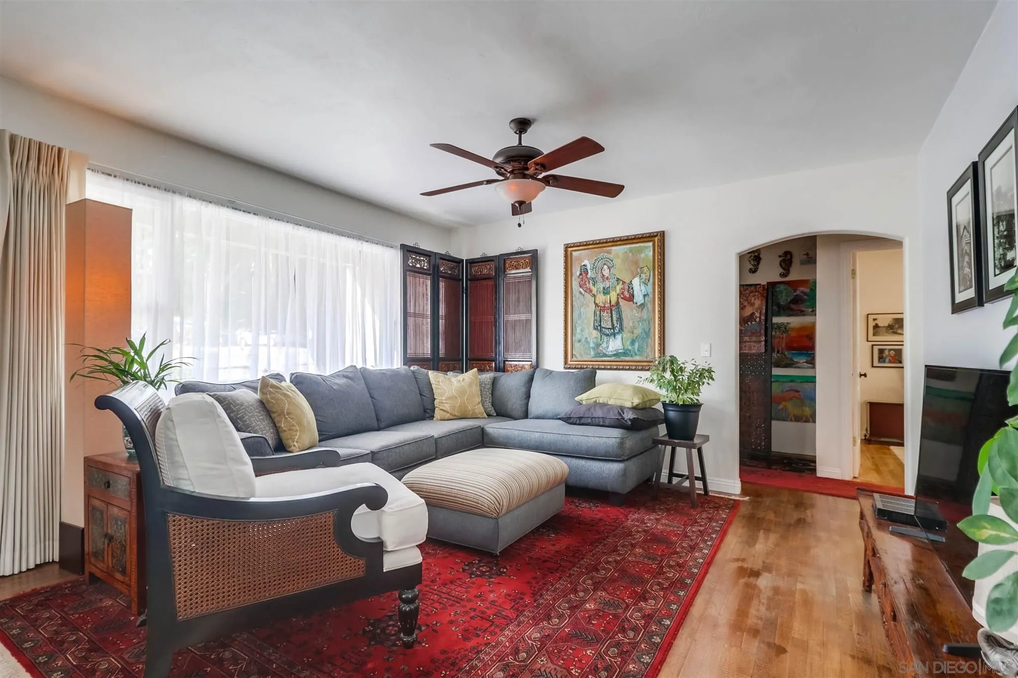 10436 Don Pico Road Spring Valley, CA 91978 - Photo 5 of 25 a living room with furniture a flat screen tv and a fireplace