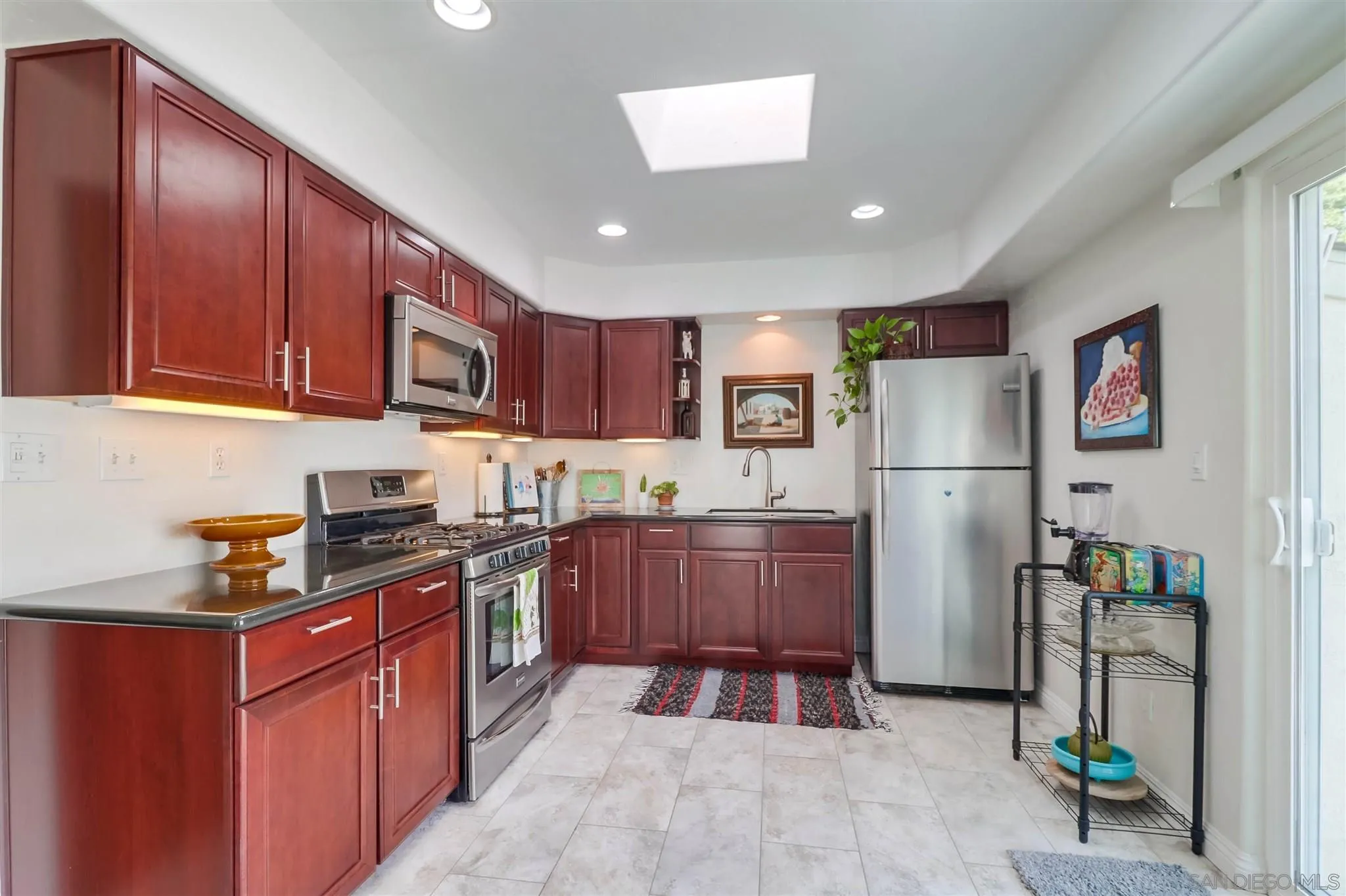 10436 Don Pico Road Spring Valley, CA 91978 - Photo 7 of 25 a kitchen with stainless steel appliances granite countertop a refrigerator stove a sink and a dishwasher