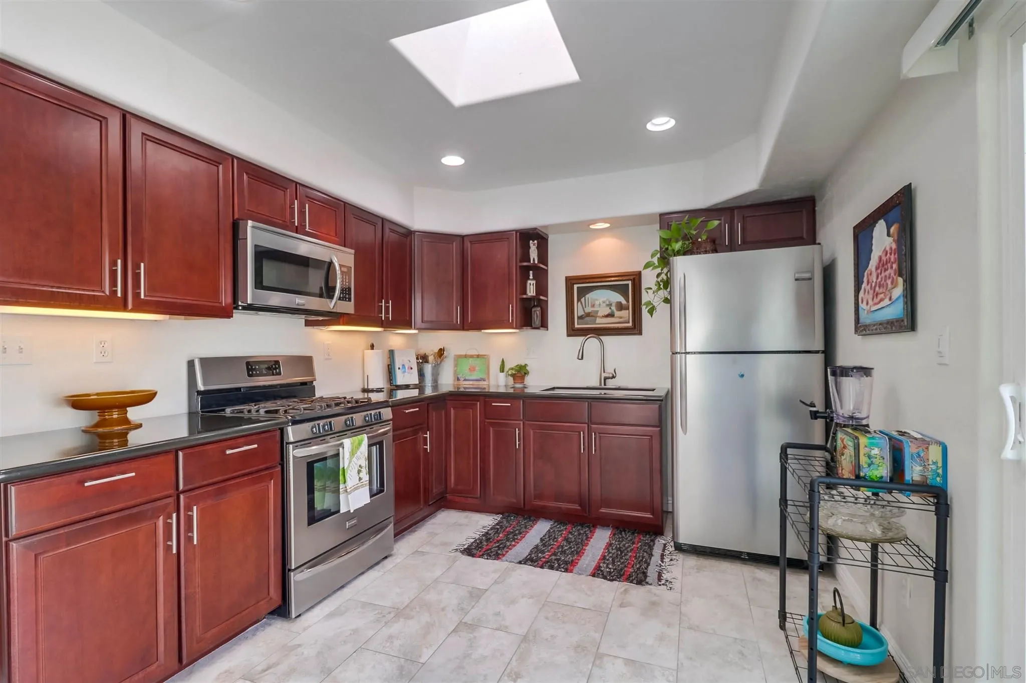 10436 Don Pico Road Spring Valley, CA 91978 - Photo 8 of 25 a kitchen with stainless steel appliances granite countertop a refrigerator a stove top oven a sink and dishwasher