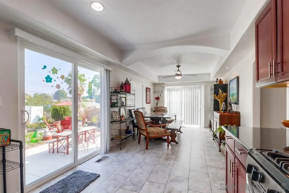 10436 Don Pico Road Spring Valley, CA 91978 - Photo 10 of 25 a living room with furniture a flat screen tv and a floor to ceiling window