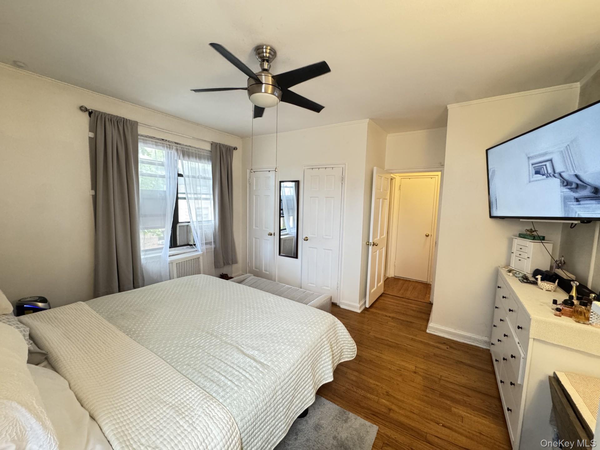 2208 76th Street, Unit A3 Queens, NY 11370 - Photo 3 of 6 a bedroom with a large bed and a window