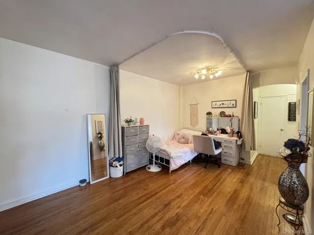 a bed room with furniture and wooden floor