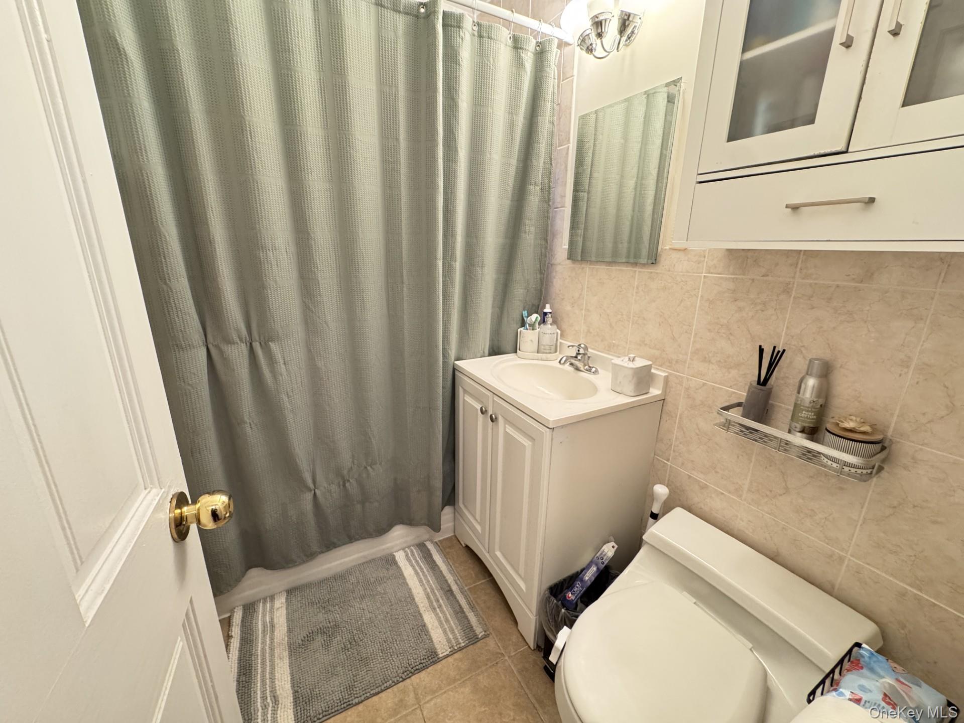 2208 76th Street, Unit A3 Queens, NY 11370 - Photo 6 of 6 a bathroom with sink and mirror