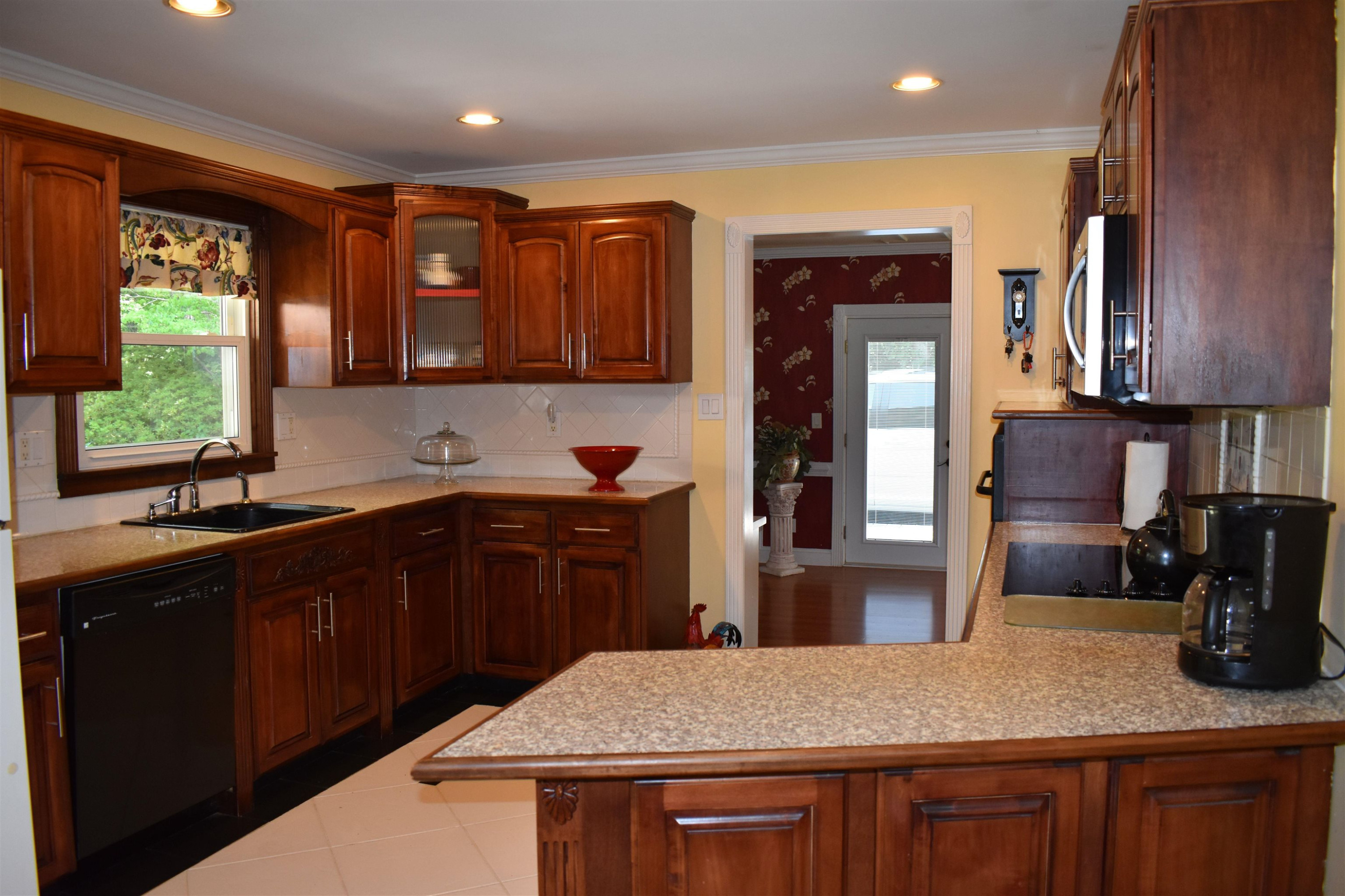 512 Grovemont Road Raleigh, NC 27603 - Photo 7 of 23 Custom cabinetry w/big drawers for pots & pans, Farm house style sink w/2 sides, arch spigot, water spigot & soap spigot, refrigerator! Kitchen