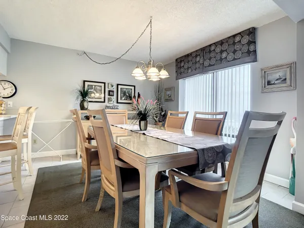 a view of a dining room with furniture and window