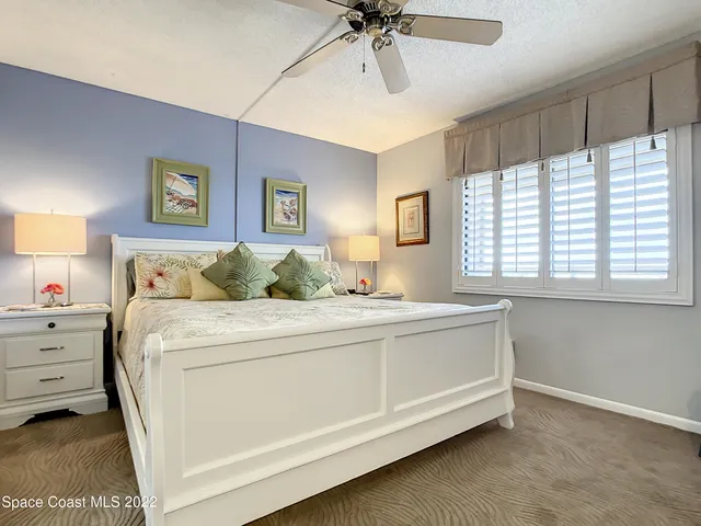 a spacious bedroom with a bed and a window