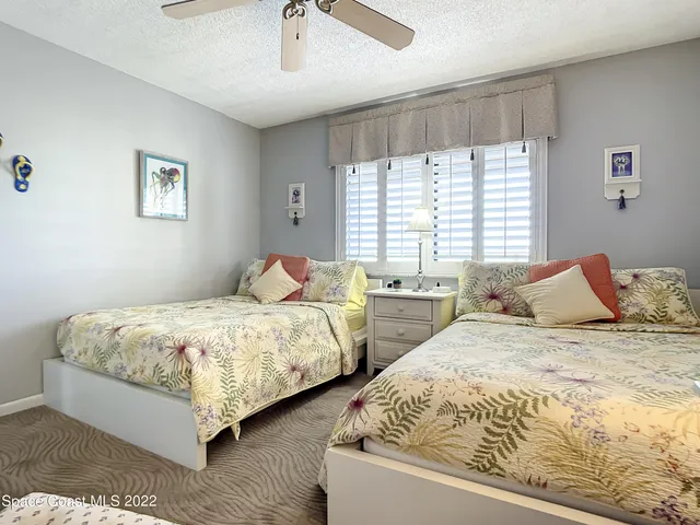 a bedroom with two beds and a window