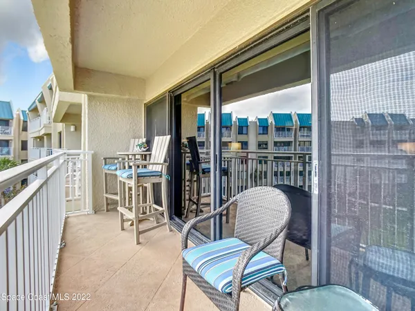 a view of two chairs in the balcony