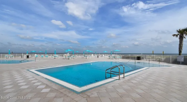 a view of a swimming pool and an outdoor seating