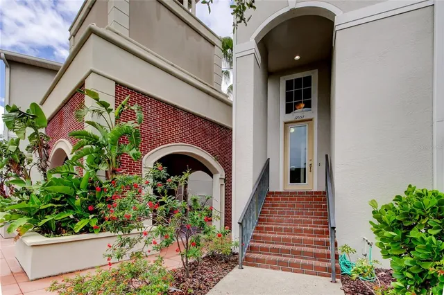 a front view of a house with plants