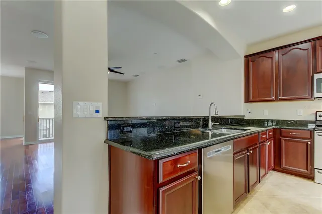 a kitchen with granite countertop a sink and cabinets